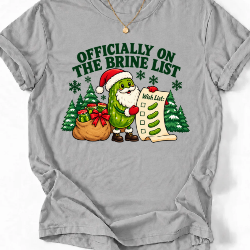 Sport Grey T-shirt with “Officially on the Brine List” text and a Santa pickle holding a wish list beside Christmas trees.
