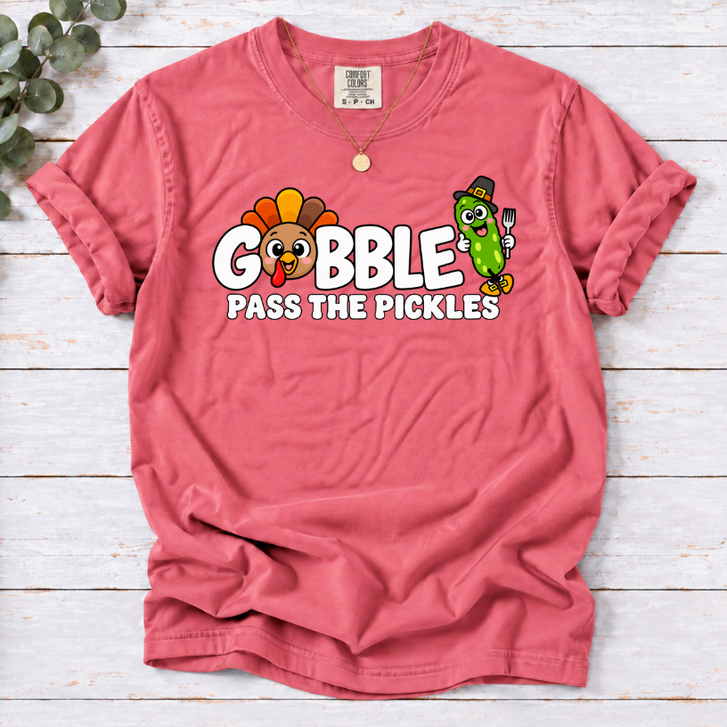 Watermelon T-shirt with ‘Gobble Pass the Pickles’ lettering, a cartoon turkey and a pilgrim pickle holding a fork.