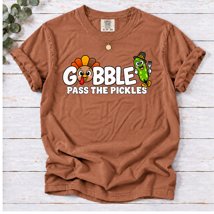Yam T-shirt with ‘Gobble Pass the Pickles’ lettering, a cartoon turkey and a pilgrim pickle holding a fork.